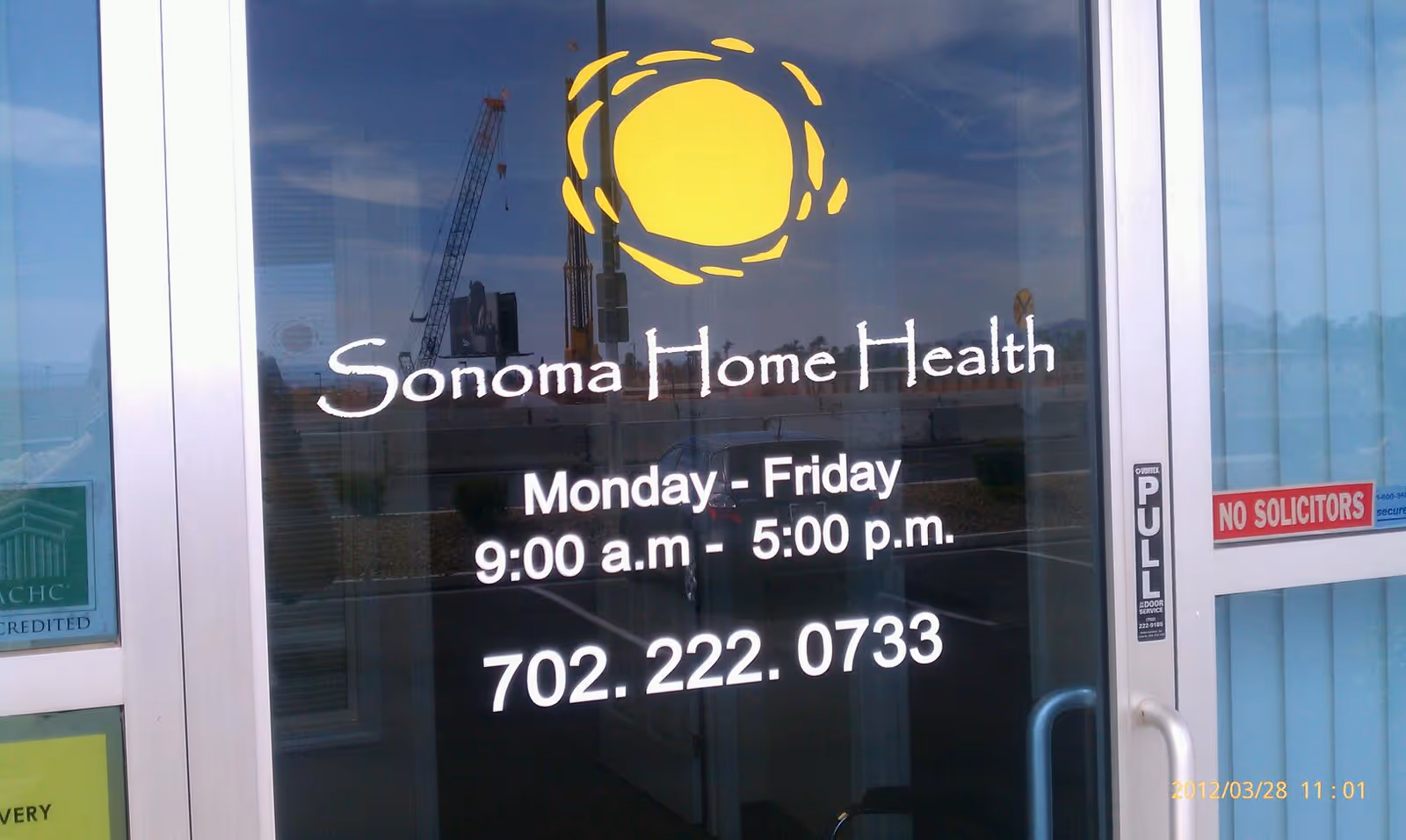 Glass entry door displaying Sonoma Home Health Care Inc logo and business hours.