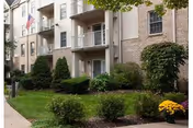 Exterior view of Hanover Hall's front facade with balconies and manicured shrubs.