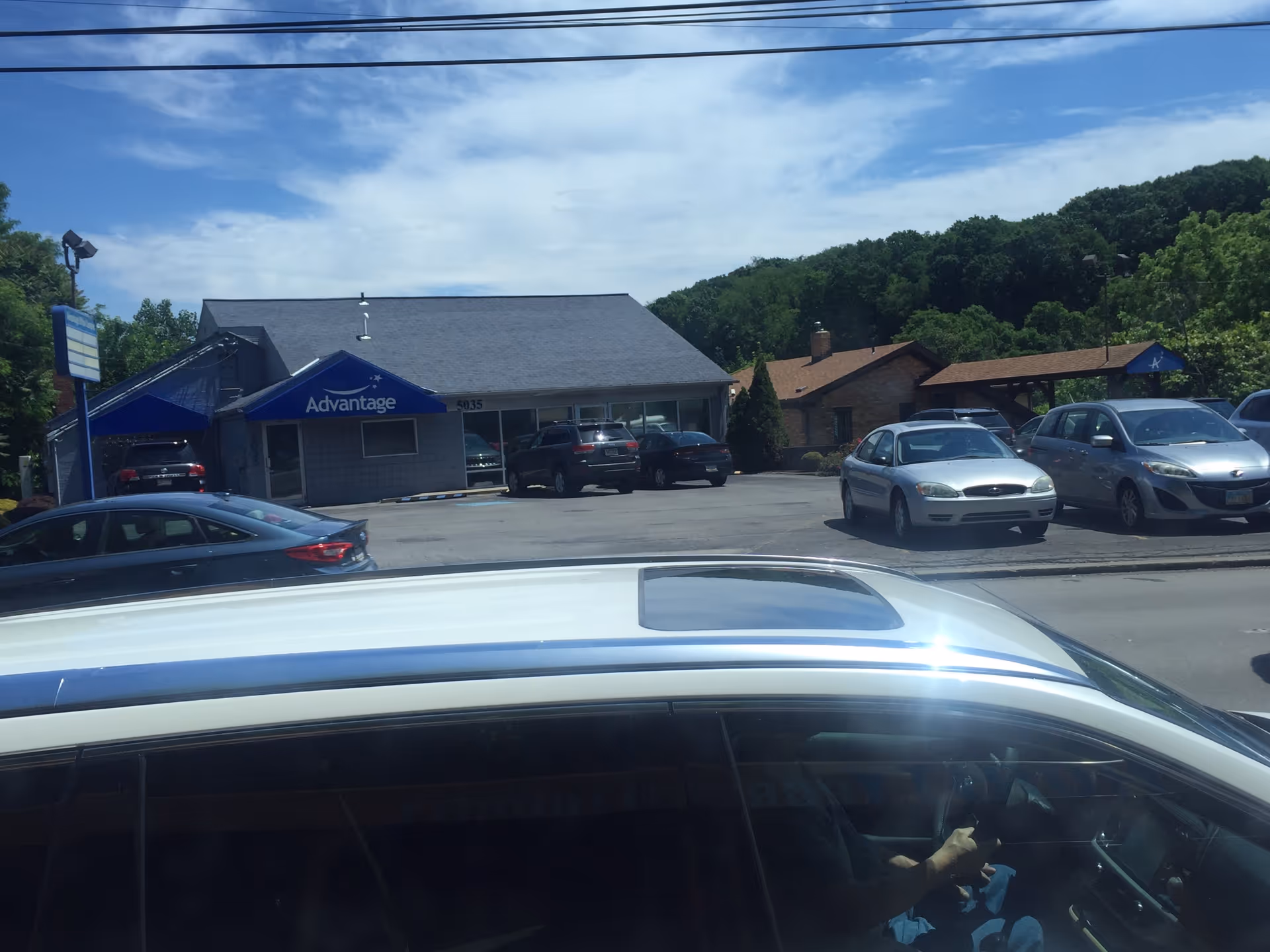 Exterior view of Advantage Home Health and Hospice building with parked cars in front.