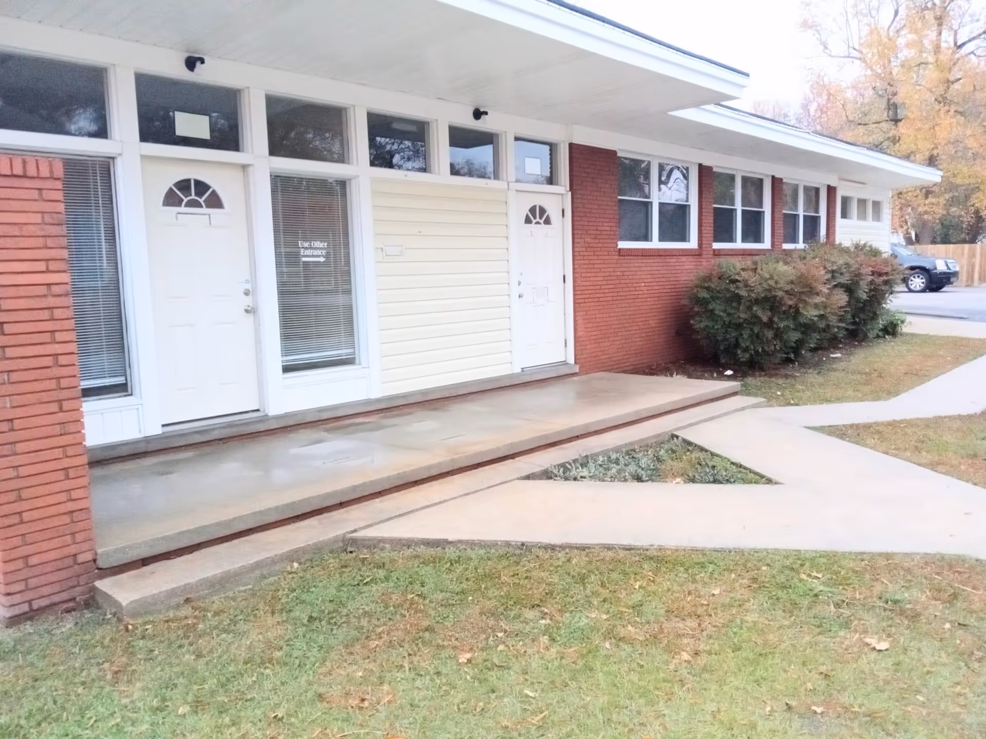 Exterior view of Ozah Home Care Inc facility with brick walls and white entrance doors.