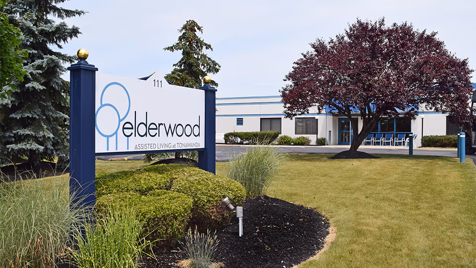 Exterior view of Elderwood Assisted Living at Tonawanda with front sign and entrance.