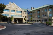 Exterior view of Gino J Merli Veterans Center entrance with flags.