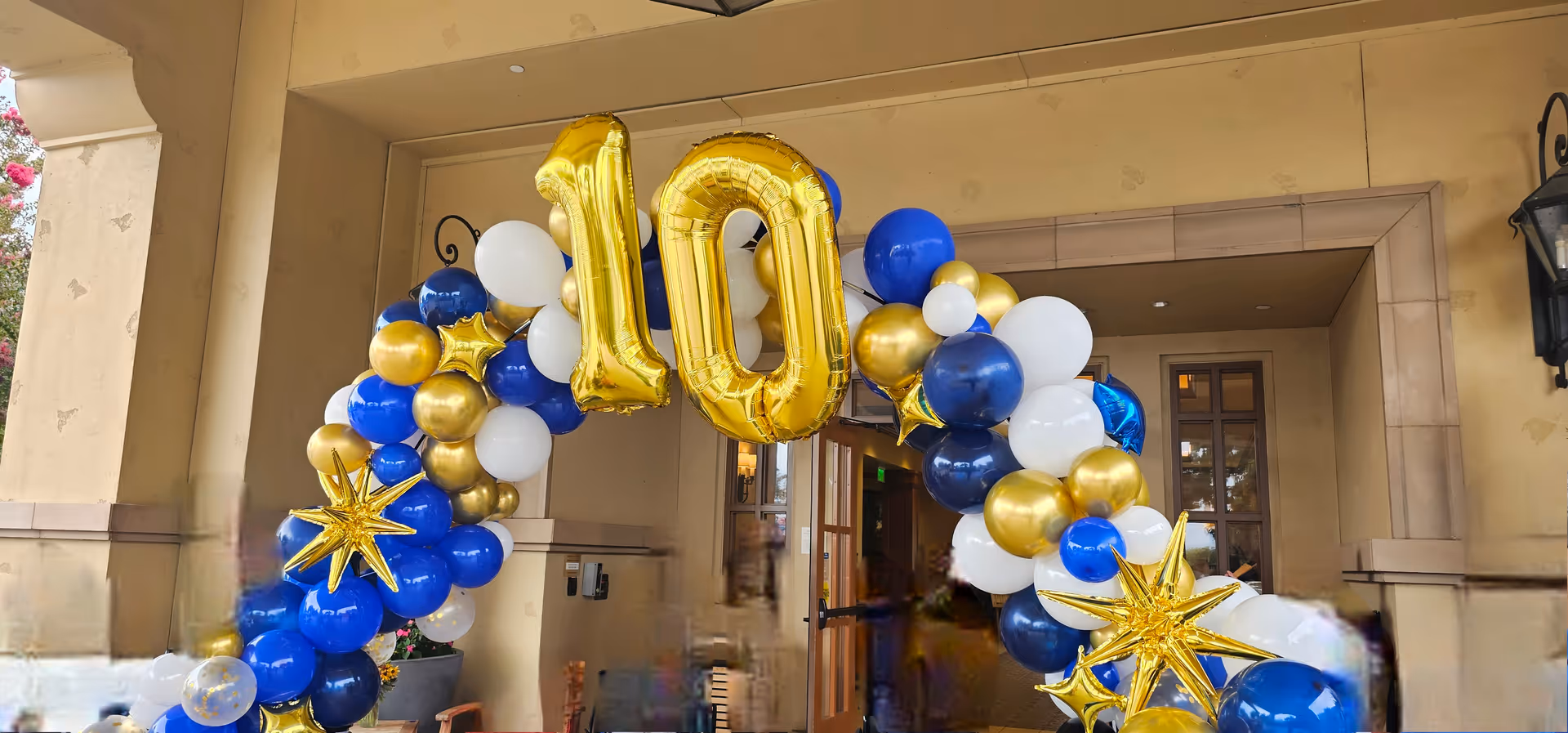 Entrance to Creekview Assisted Living decorated with blue, white, and gold balloons.