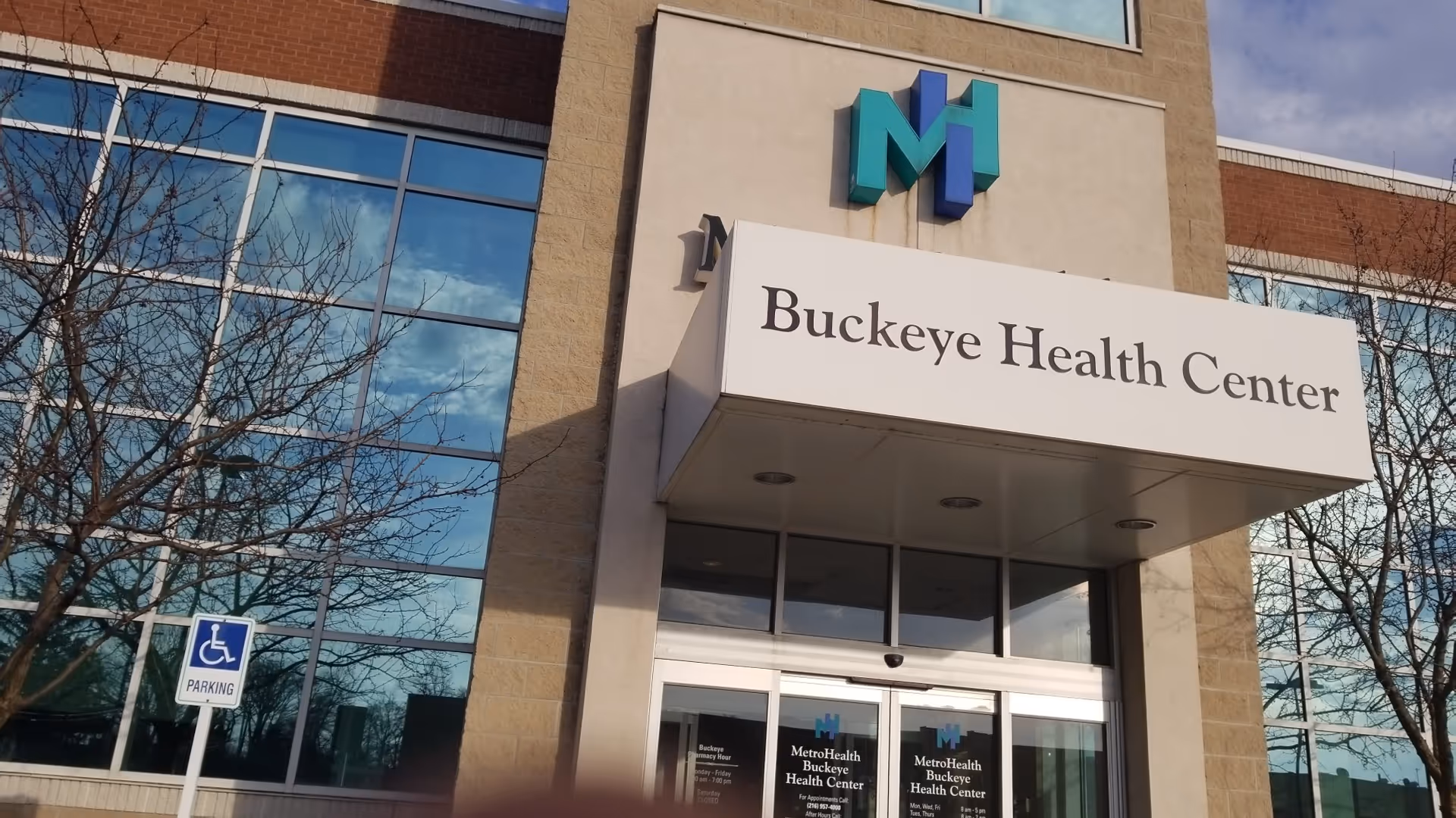 Front entrance of MetroHealth Buckeye Health Center with large glass windows.