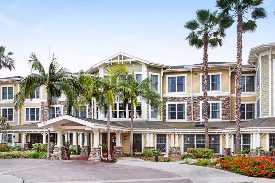 Exterior view of Ivy Park at Seal Beach with palm trees and a covered entrance.