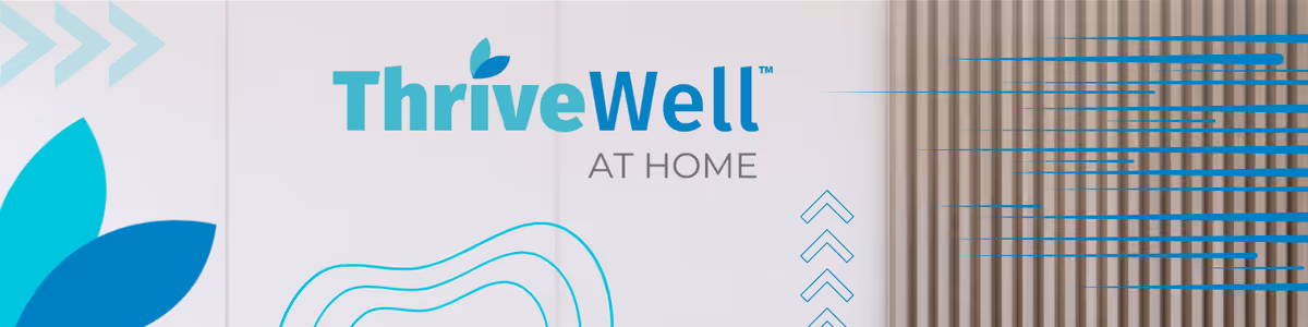 ThriveWell At Home logo on a white exterior wall with blue graphics.