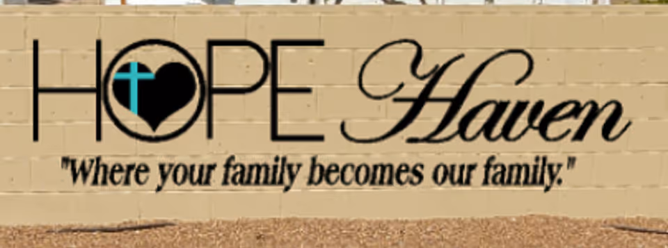 Exterior beige wall sign reading Hope Haven with a slogan.