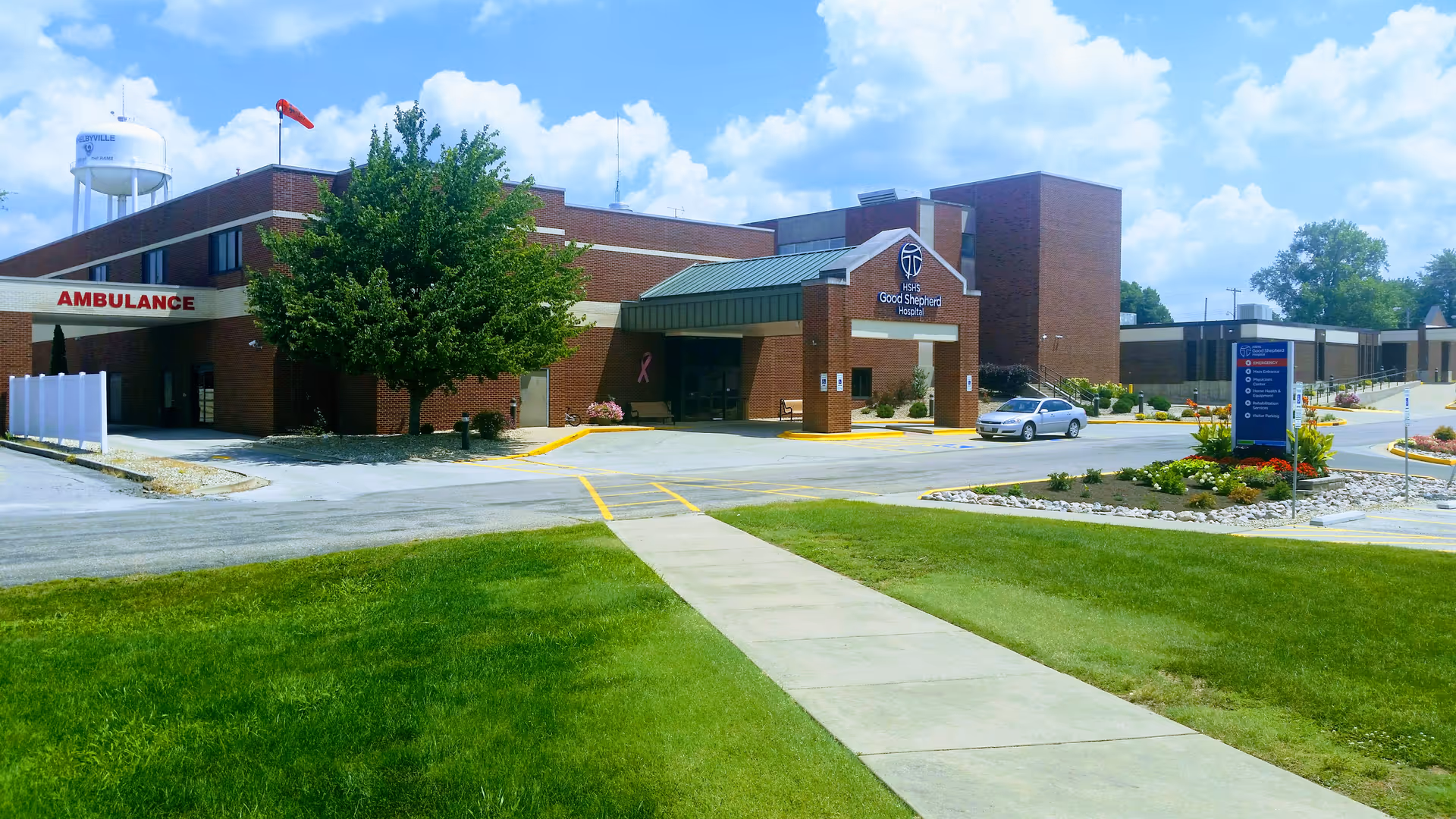 Exterior view of HSHS Good Shepherd Hospital with ambulance bay and front entrance.