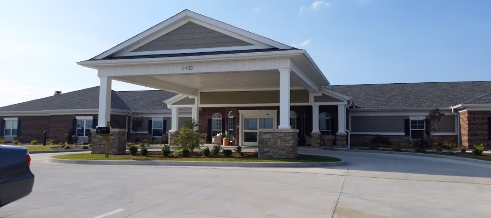 Parkside senior living facility exterior with a covered entry and brick facade.