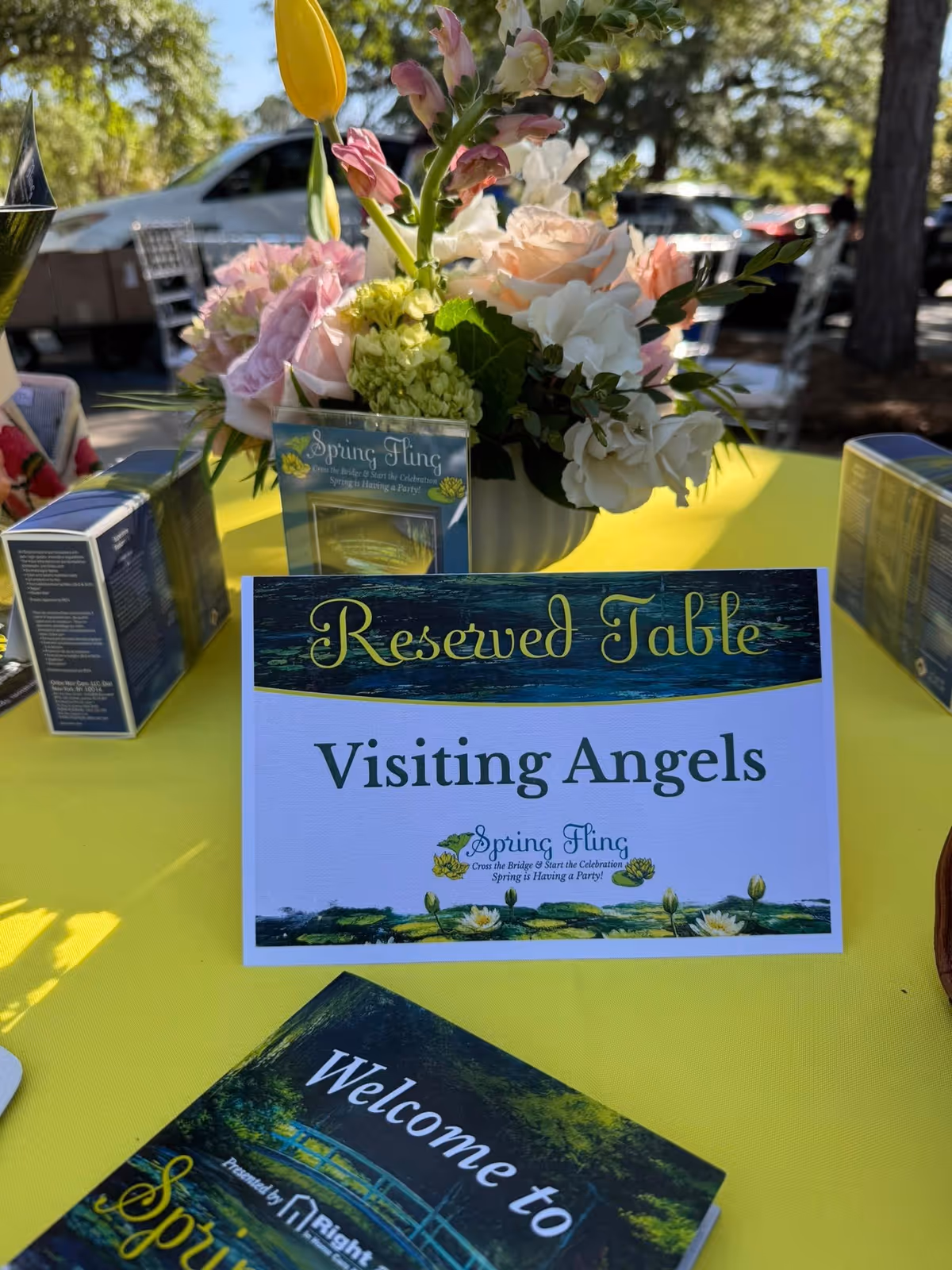 Outdoor table setup with flowers and a Reserved Table sign for Visiting Angels