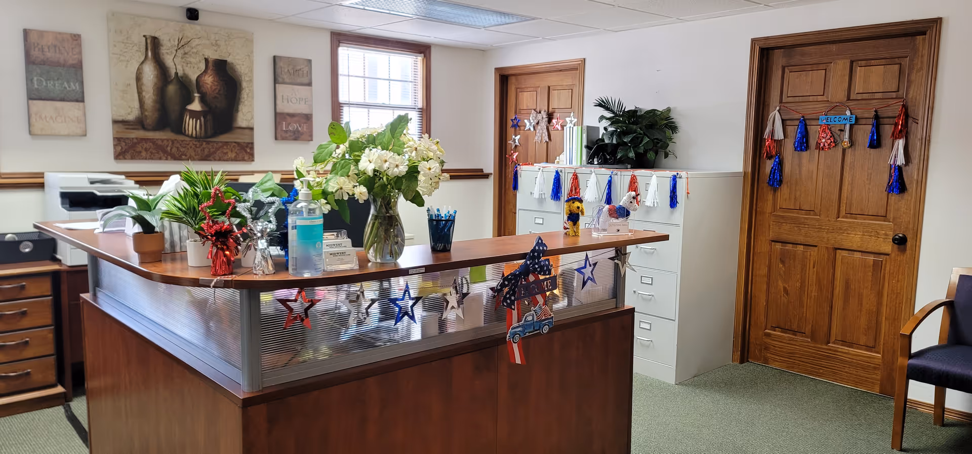 Interior reception area at Midwest Home Health Care with festive decor and plants.