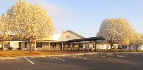 Exterior view of Rolling Ridge facility with a parking lot and entrance canopy.