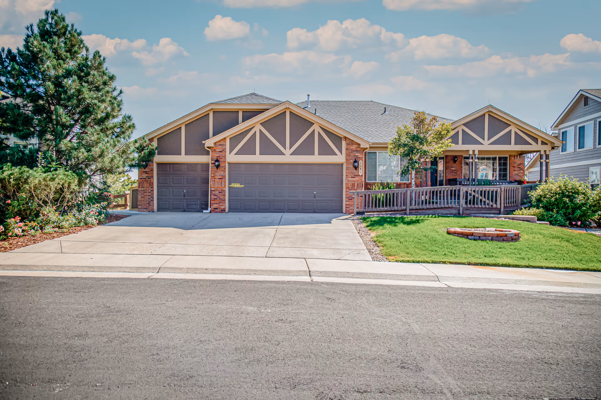 Front exterior of Castle Rock Assisted Living, a single-story facility with a three-car garage and porch.