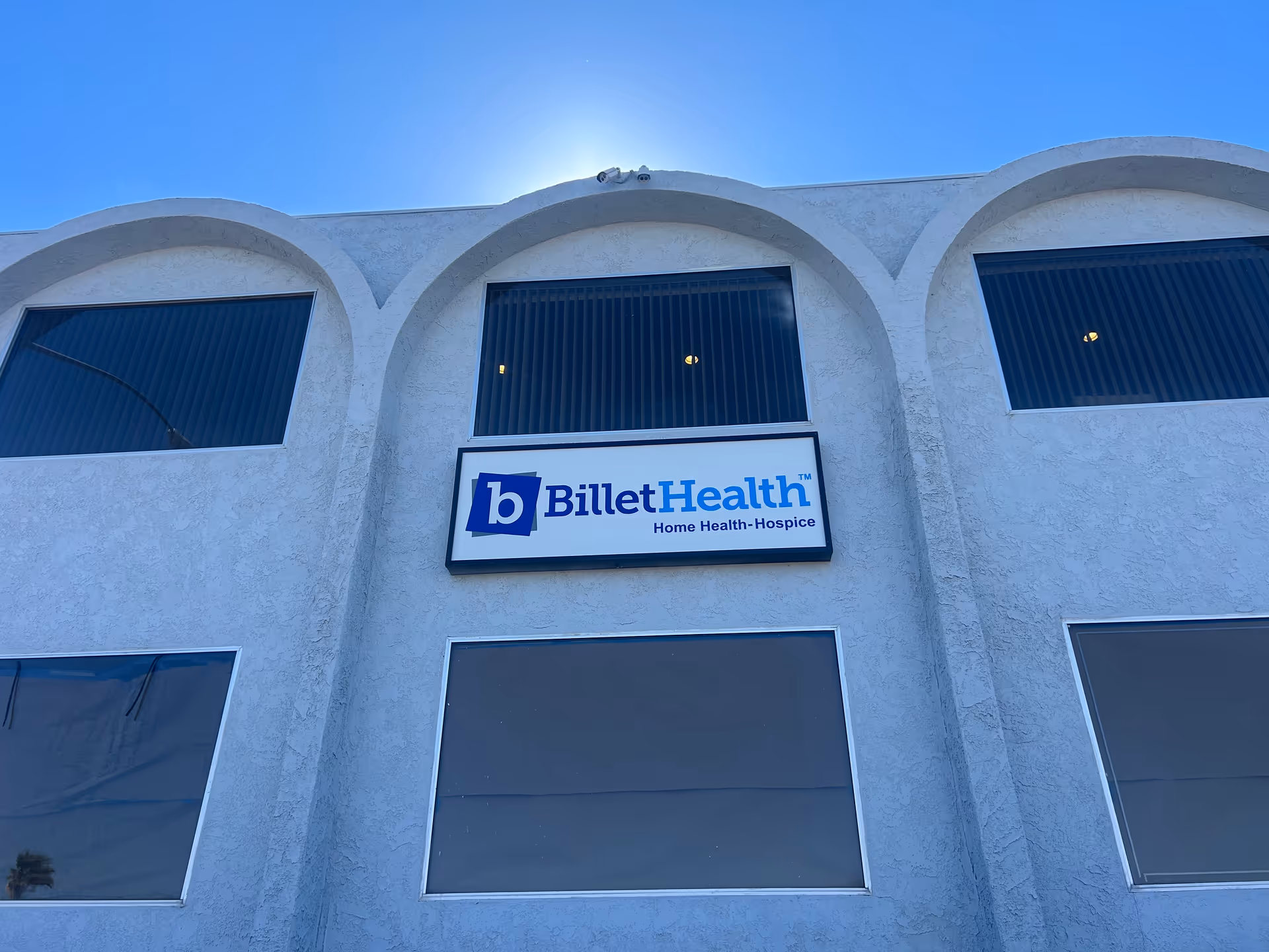 Exterior view of Billet Health building facade with arched windows and sign