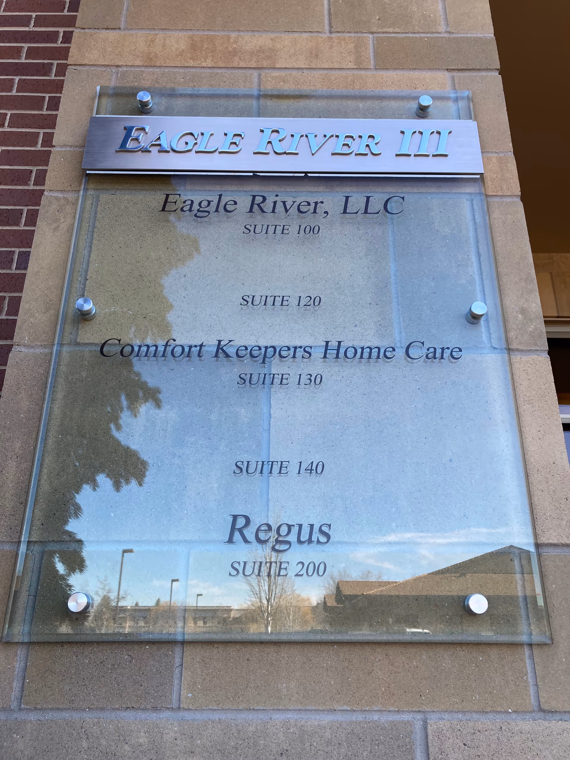Exterior building sign listing Eagle River III and Comfort Keepers Home Care suites