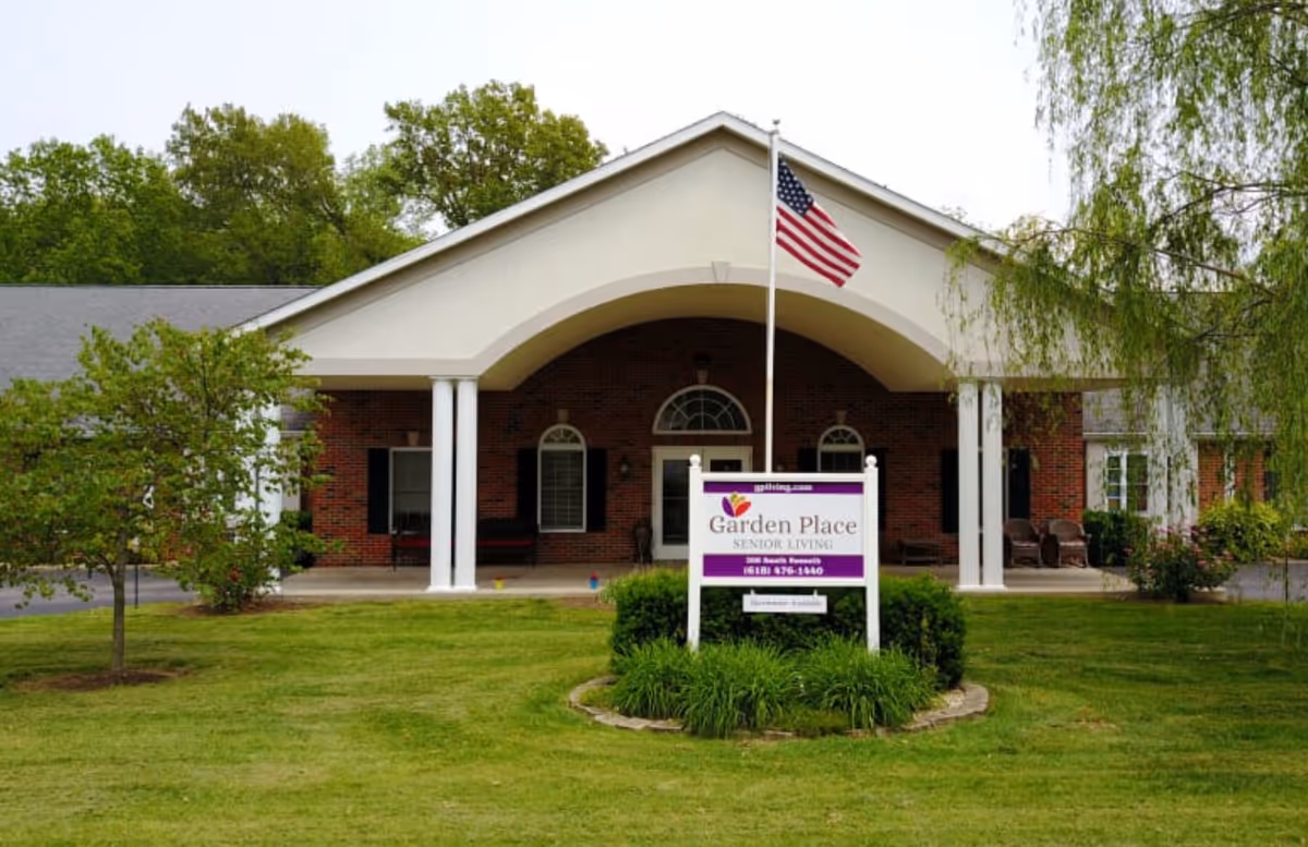Front view of Garden Place Millstadt senior living building with American flag.