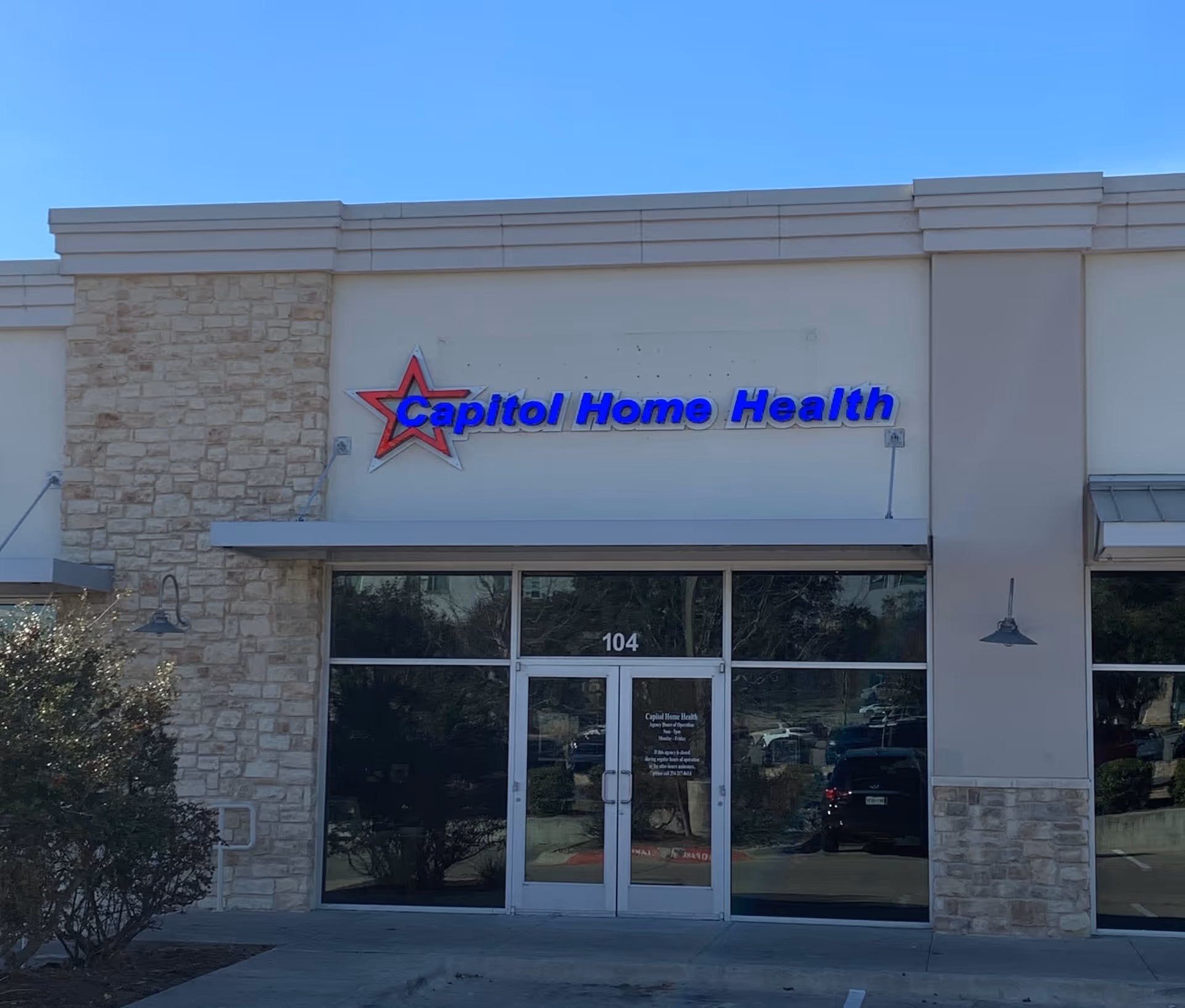 Front of Capitol Home Health facility with sign and glass entrance doors.