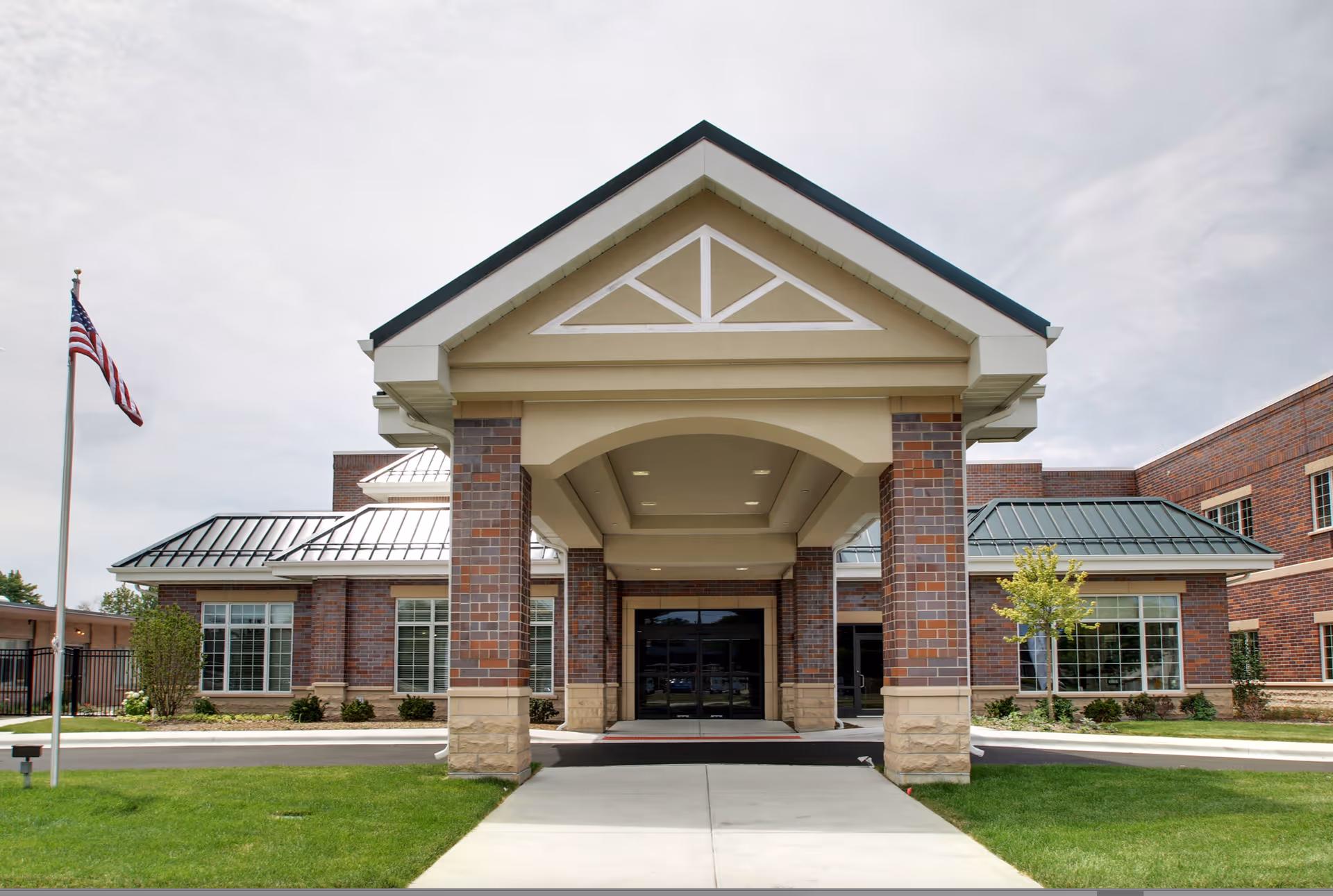Exterior front entrance of Bria of Palos Hills with brick columns and walkway.