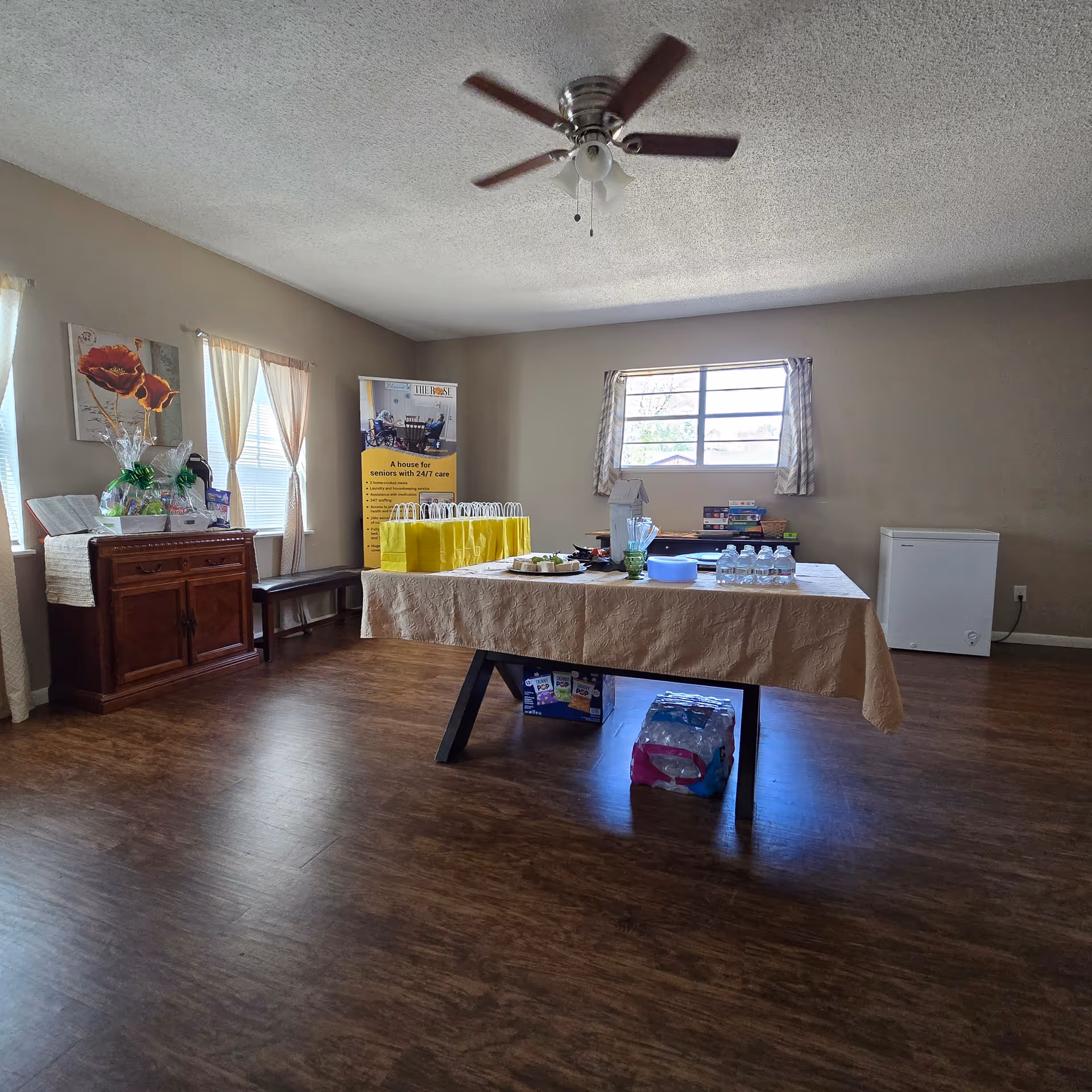 An interior room at The Rose Residential Care Home with a long table and supplies.