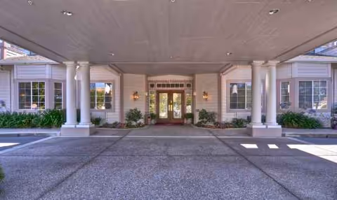 Covered driveway leads to glass doors at Ivy Park at San Ramon entrance.