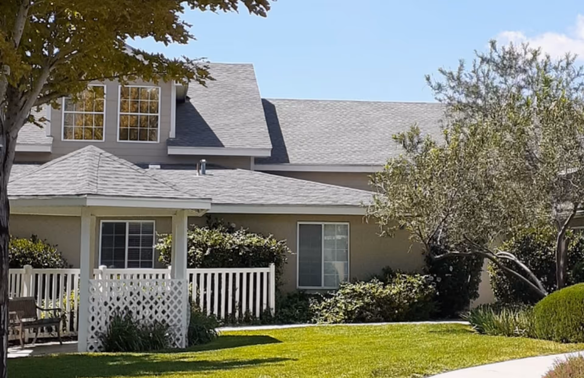 Exterior view of a gray Avista Senior Living Albuquerque building with a covered porch.