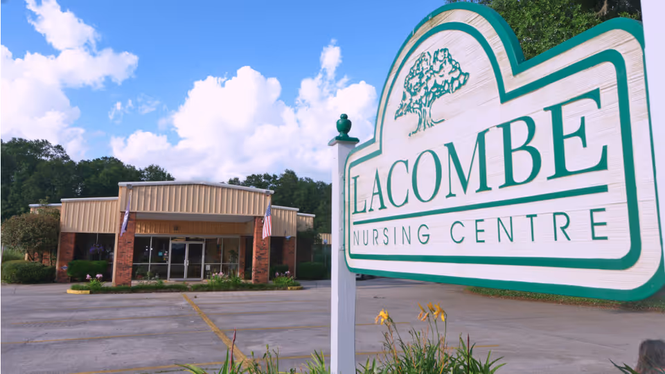 Exterior view of Lacombe Nursing Centre with a large sign and entrance.