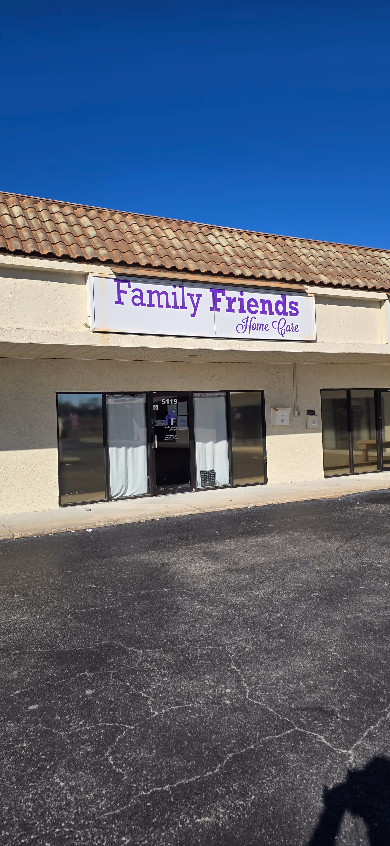Exterior view of a beige storefront with a Family Friends Home Care sign.