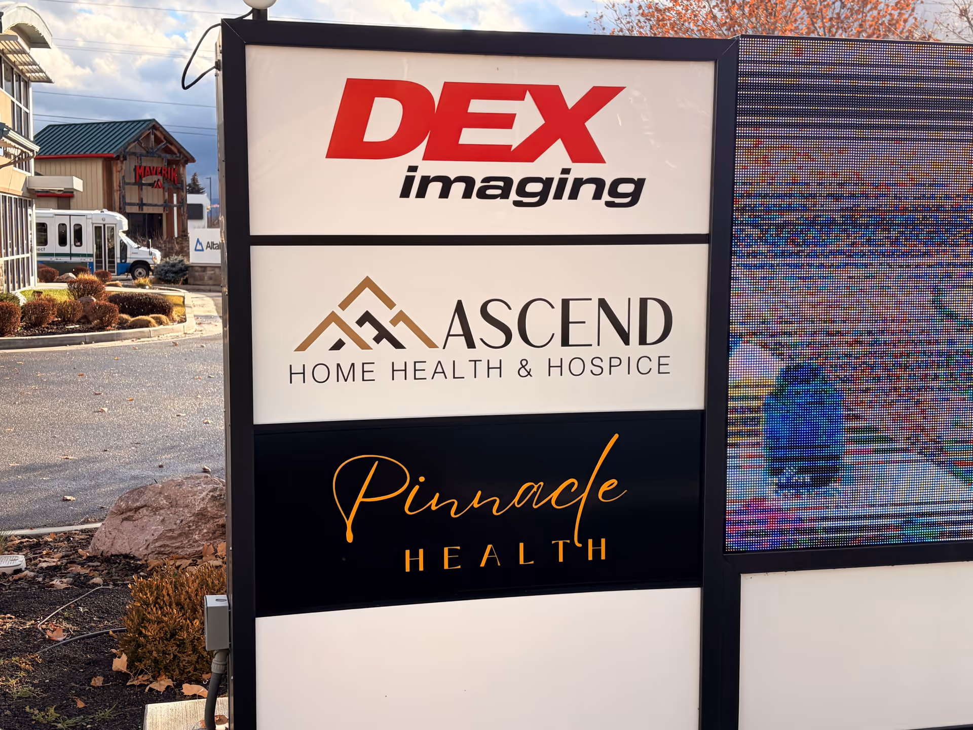 Outdoor signboard displays DEX Imaging and Ascend Home Health & Hospice logos.