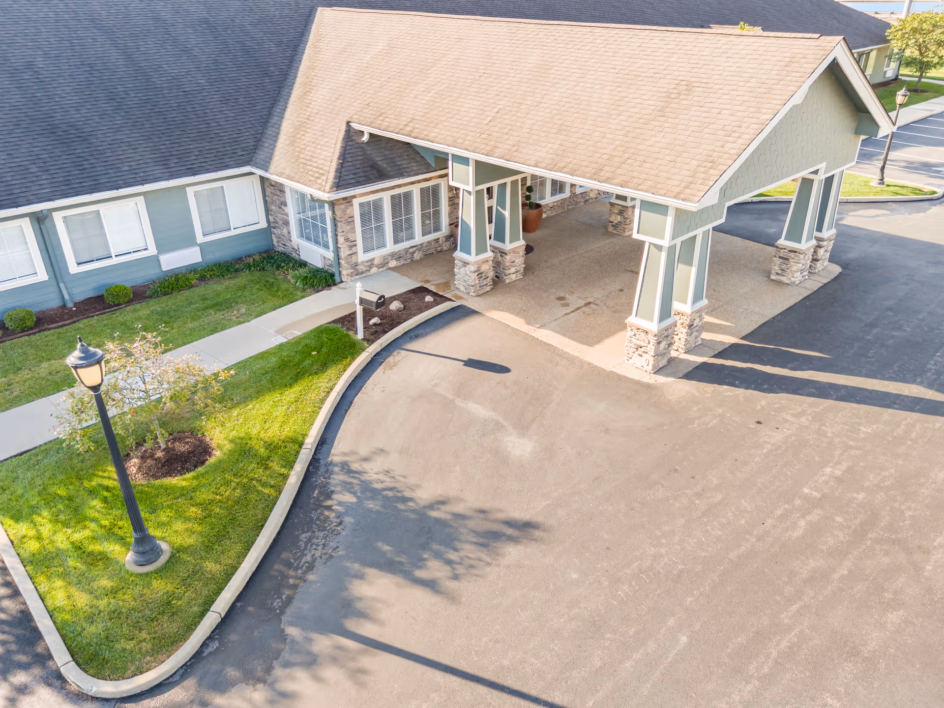 Aerial view of the facility entrance with porte-cochere and curved driveway.