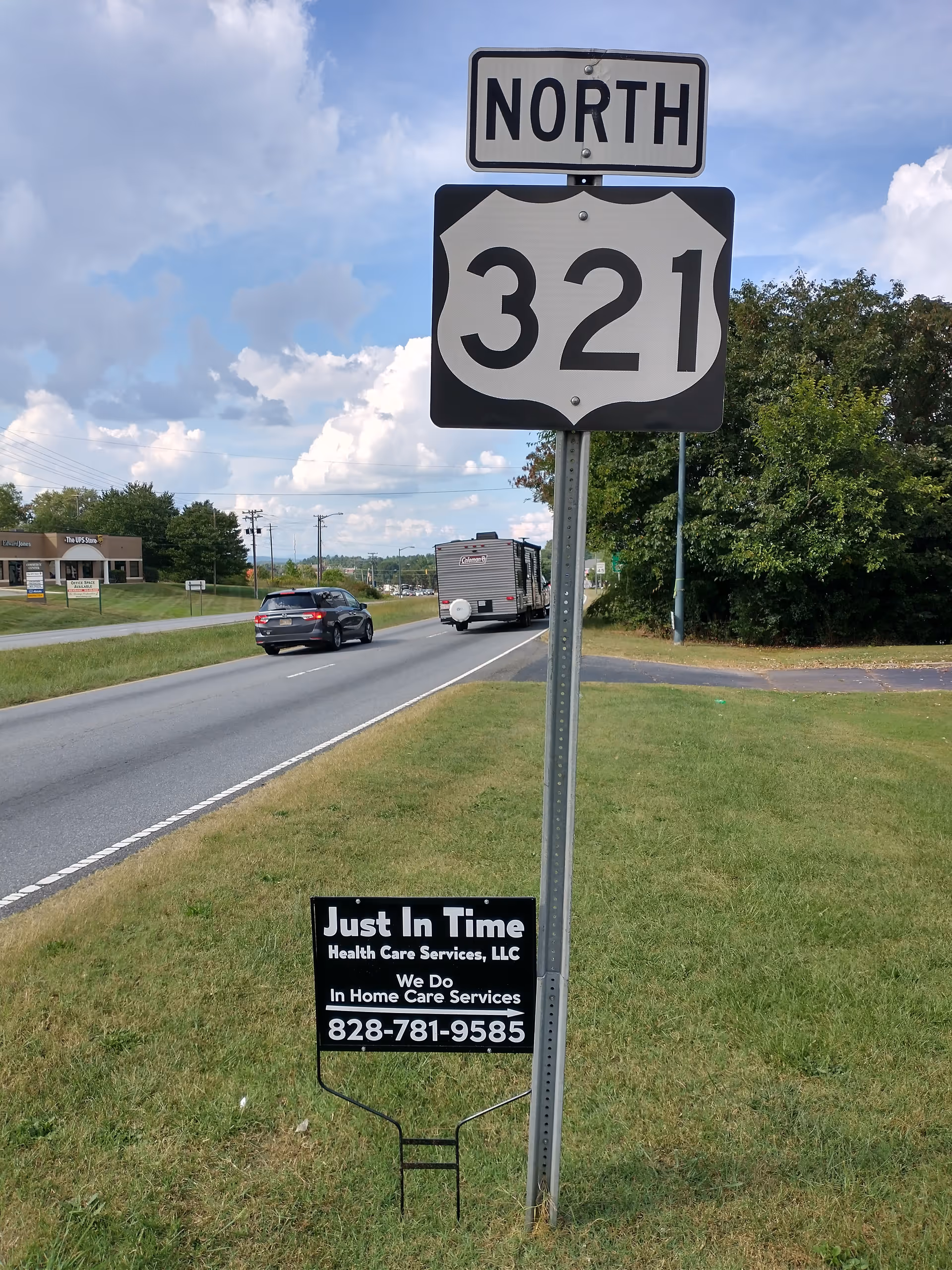 Roadside scene with North 321 sign and a sign for Just In Time Health Care Services.