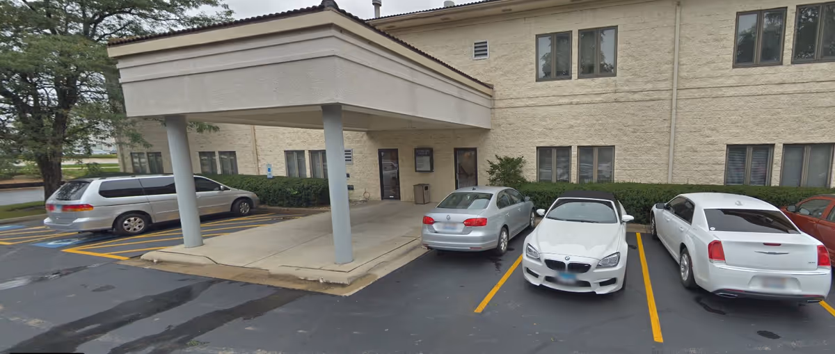 Front exterior of Abcor Home Health Woodridge with a covered entrance and parked cars.