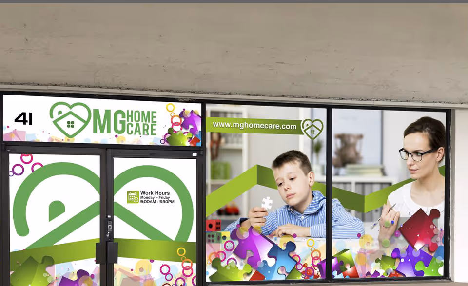 Storefront window display for MG Home Care with a caregiver and child puzzle-patterned graphics.