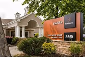 Front exterior of Marquis Care at Shasta with sign and landscaping.