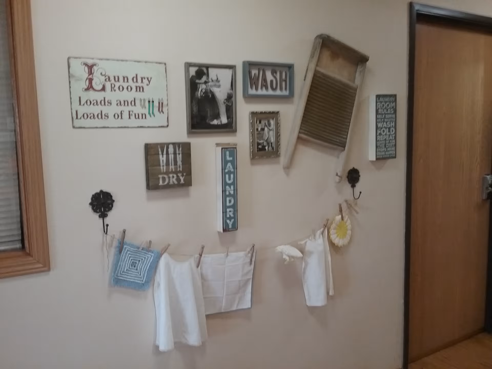 Wall decorated with laundry-themed signs and a fabric garland.