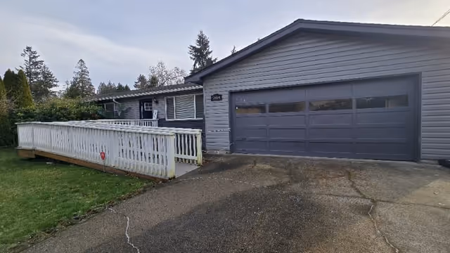 Exterior view of Carelink Senior Care facility with a gray garage door and ramp.