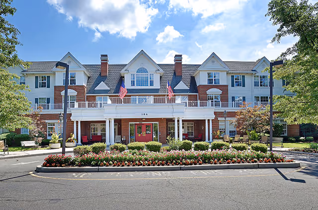 Exterior view of Juniper Village at Paramus with brick facade and landscaped entrance.