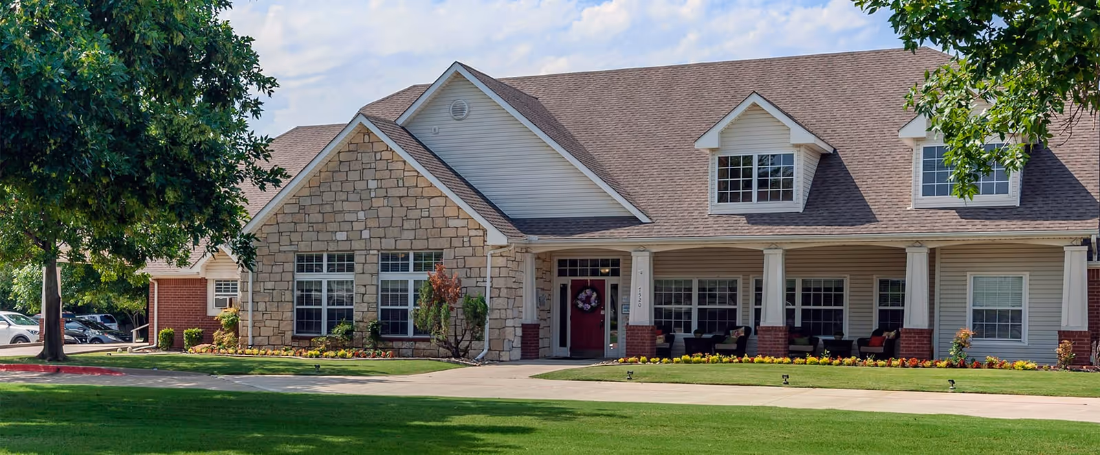Brookdale Richland Hills exterior with stone facade and covered entry, manicured lawn.