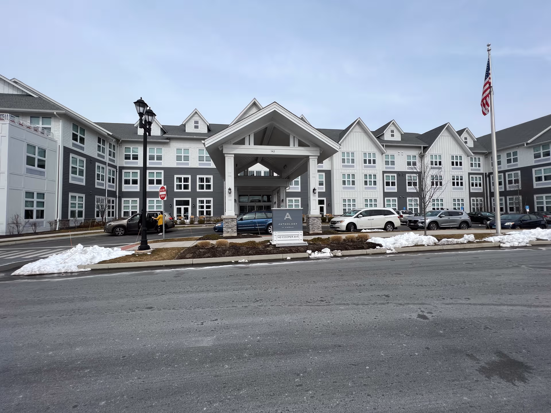Front view of Skybrooke at Simsbury, showing the entrance canopy and parked cars.