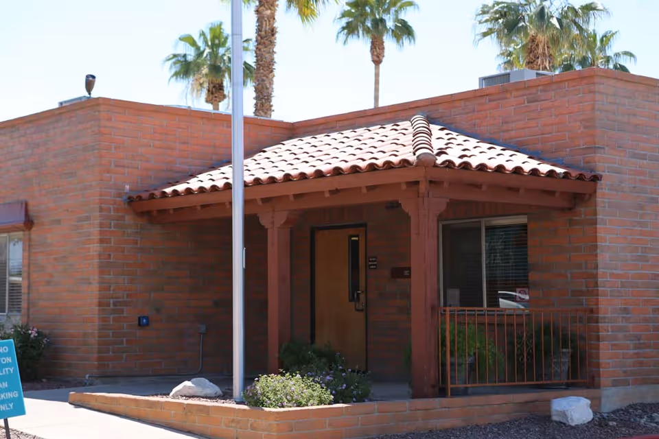 Brick exterior of Sabino Canyon Rehabilitation & Care Center with a covered entrance.