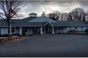 Front exterior of Spring Meadows Assisted Living Community, a single-story building with a covered entrance.