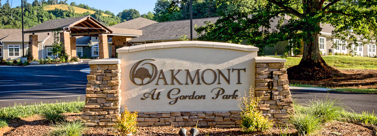 Oakmont at Gordon Park exterior entrance with stone sign and surrounding landscaping