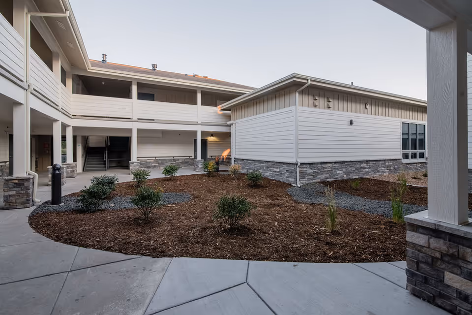 Exterior view of 2730 at Adeo senior living campus with a landscaped courtyard.