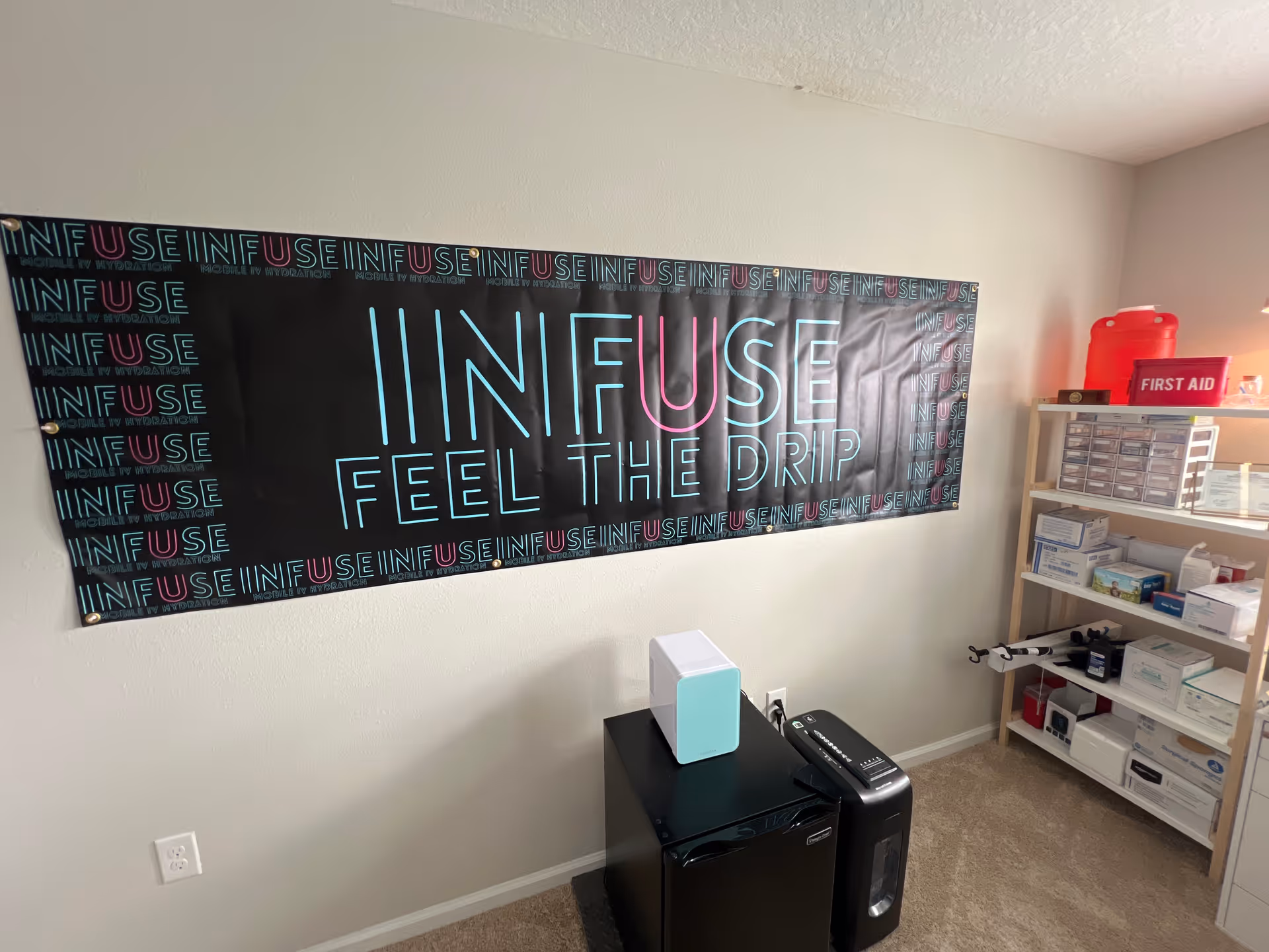 Infuse-themed interior with a large banner, medical shelves, and equipment.