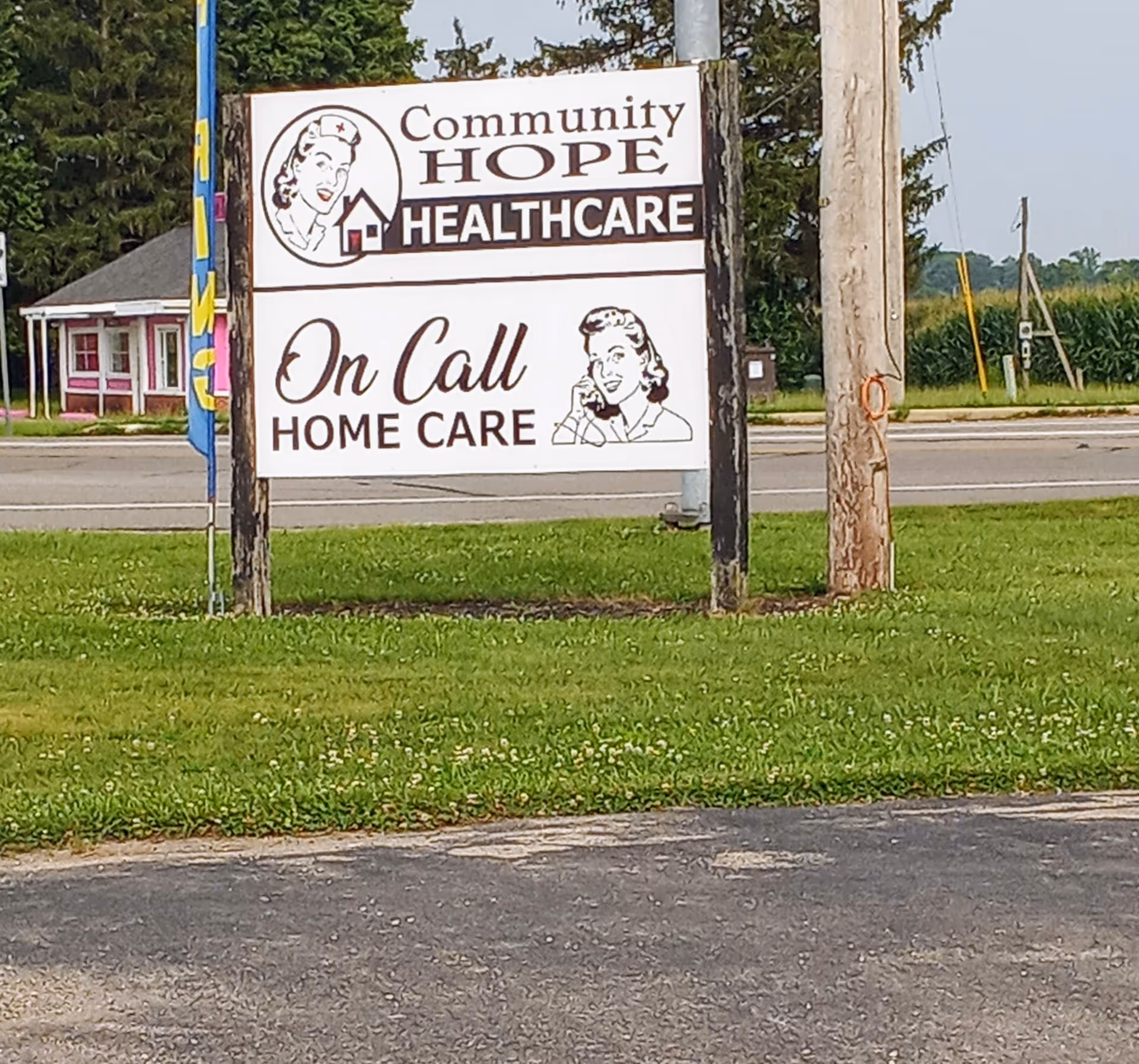 Outdoor sign for Community Hope Healthcare and On Call Home Care beside the road.