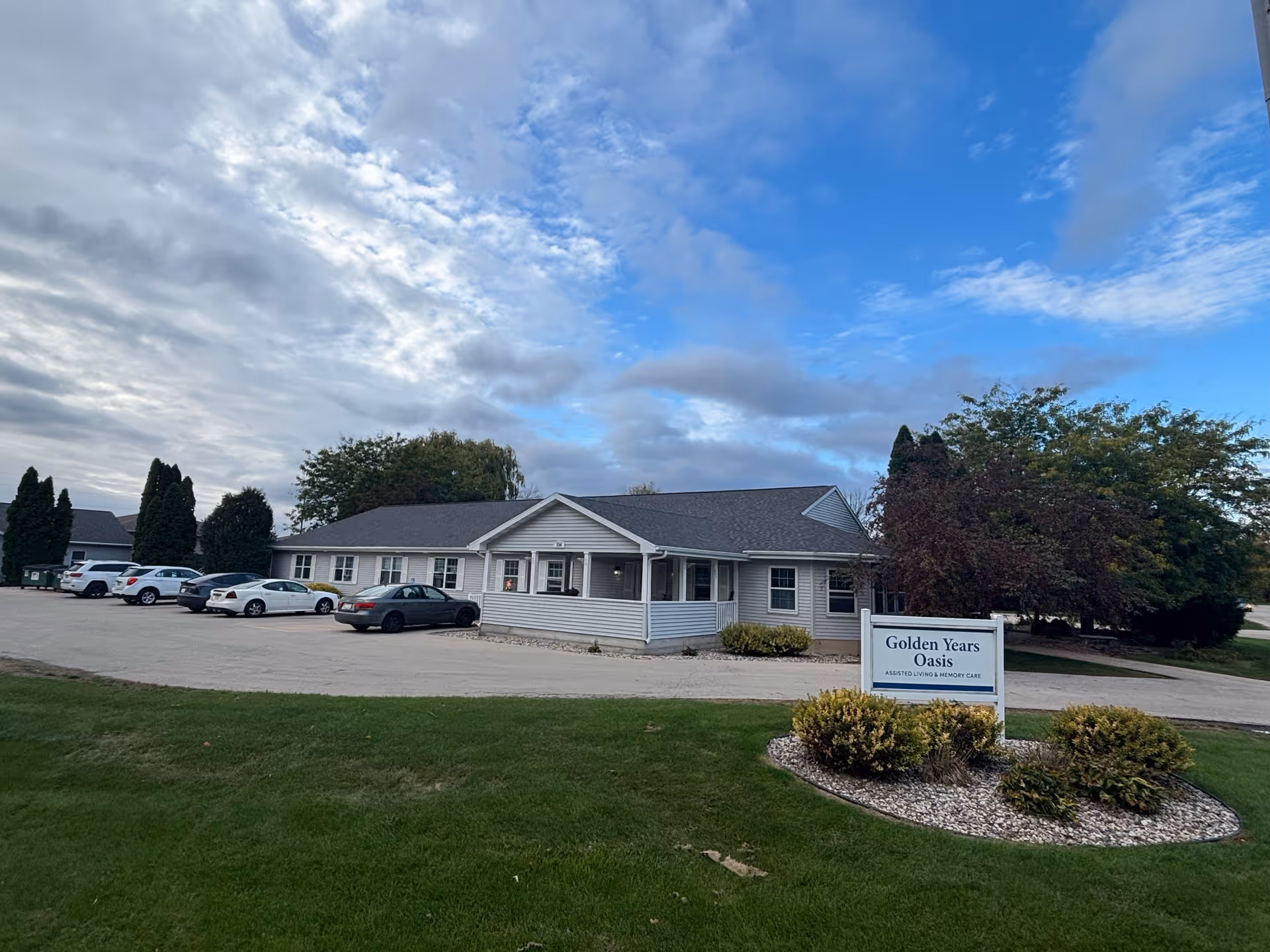 Single-story assisted living building with a front entrance and surrounding parking lot.