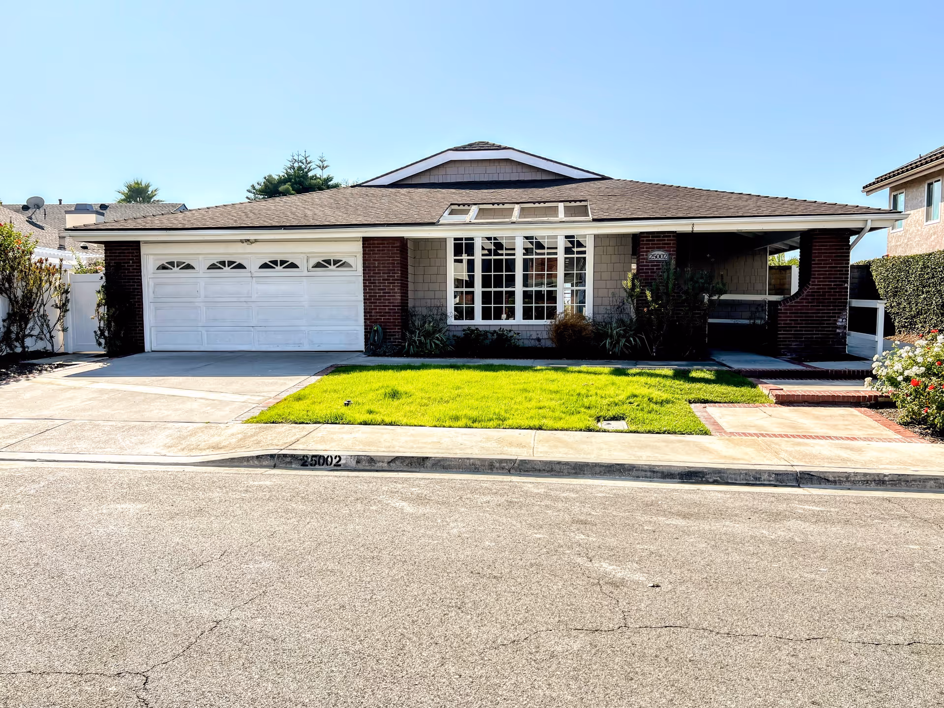 Exterior of Verona Court II, a single-story facility with a two-car garage and front lawn.