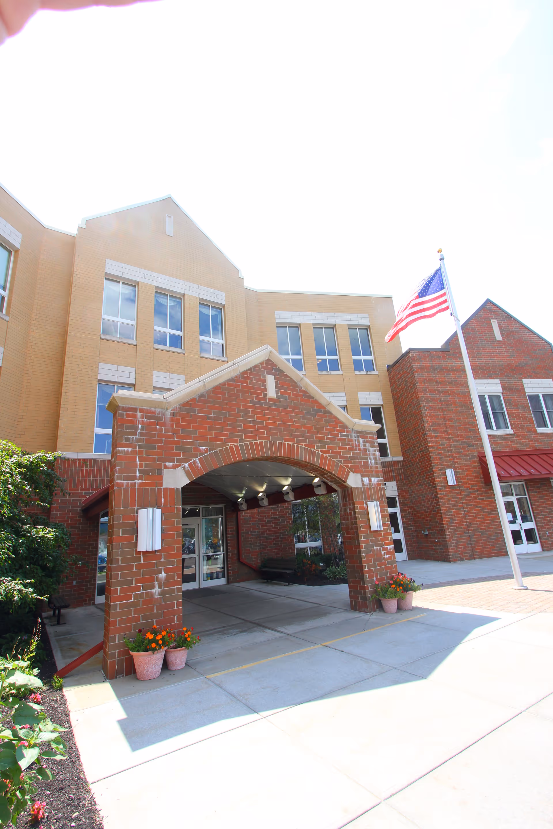 Entrance archway of Steuben Center for Rehabilitation and Healthcare exterior with flag