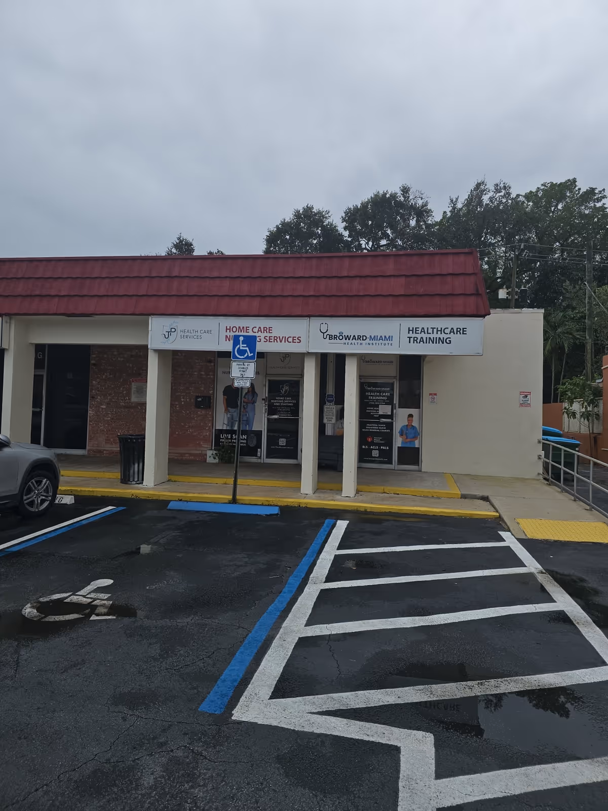 Front view of a JP Health Care Services facility with signage and handicapped parking.