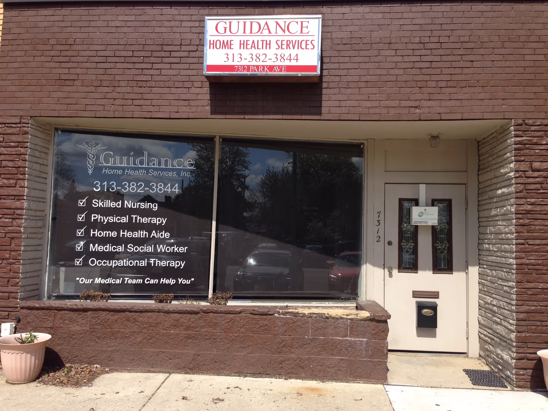 Brick storefront displaying Guidance Home Health Services sign and large front window.