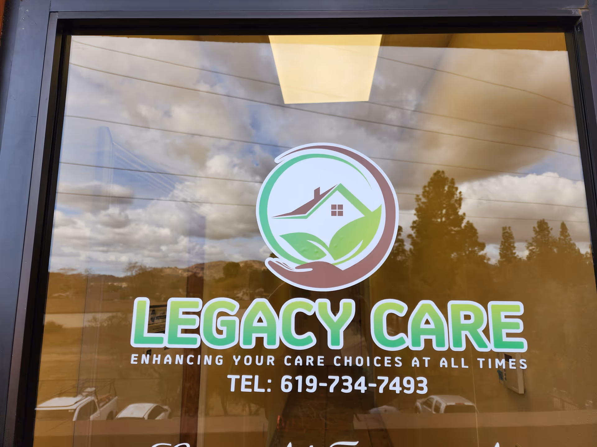 Front window sign displays Legacy Care logo and contact text with sky reflections.